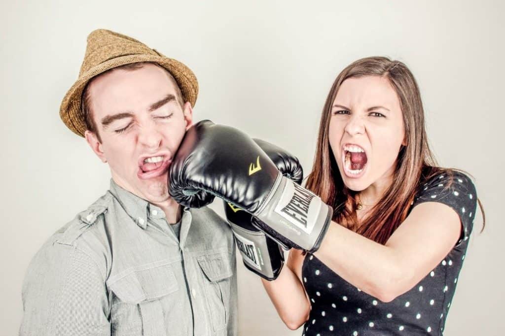 Woman punching a man in a jokey way